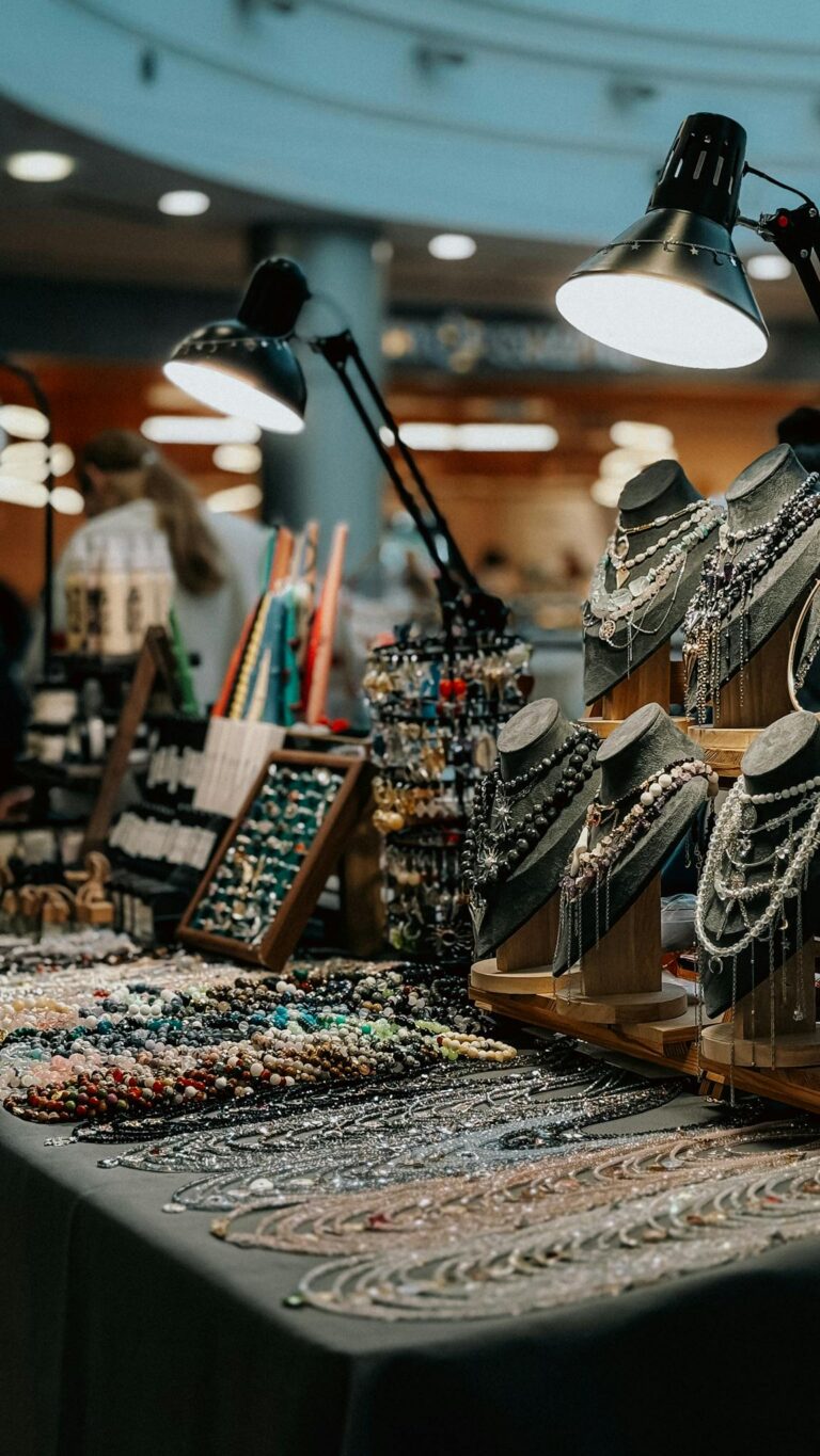Beautiful display of artisan jewelry at an indoor market, showcasing necklaces and handcrafted beads.