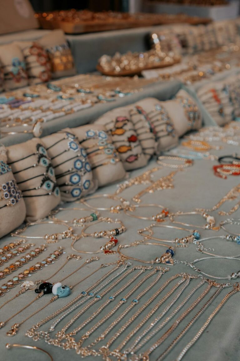 Showcase of colorful handmade jewelry with intricate designs at a market stand.